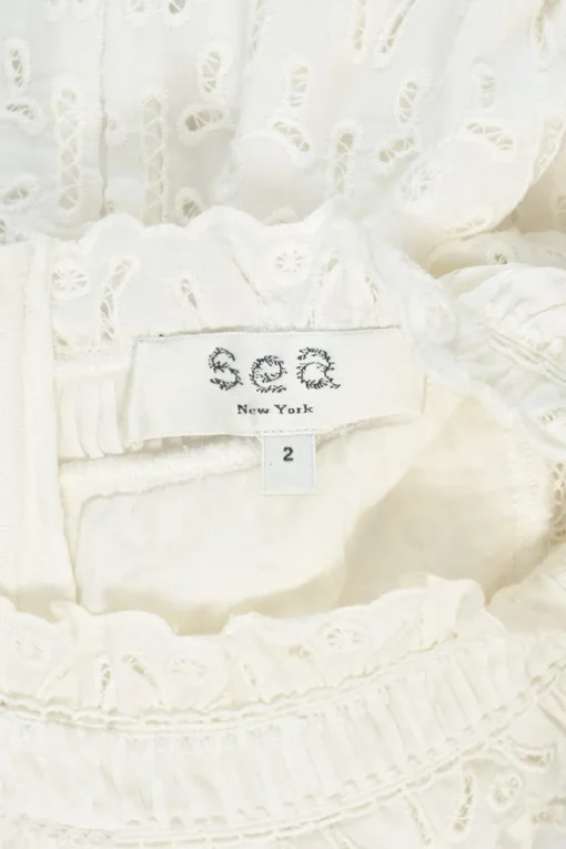 Ivory cotton broderie Anglaise ruffled high-collar sleeveless swing dress with tonal lace inserts