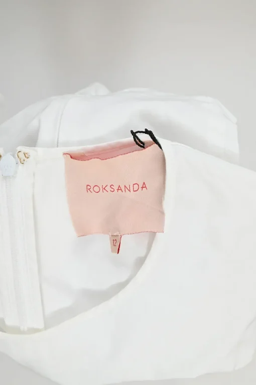 Ivory cotton poplin flounce swing-style top with knotted cuffs