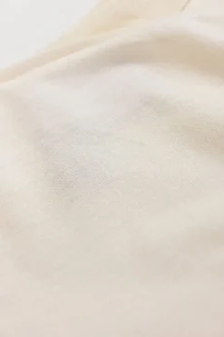 Ivory cotton-blend cap sleeve blouse with raw-edge shoulder line frill trim appliqué