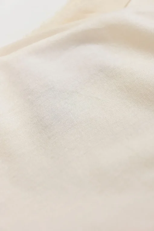 Ivory cotton-blend cap sleeve blouse with raw-edge shoulder line frill trim appliqué