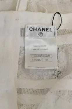 Ivory cotton-blend lace paneled peek-a-boo pullover Y-collar top with enamel Coco Mark shank button back