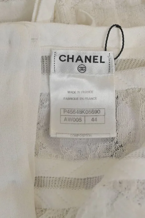 Ivory cotton-blend lace paneled peek-a-boo pullover Y-collar top with enamel Coco Mark shank button back