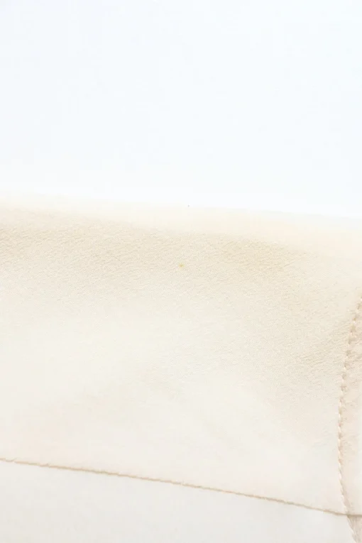Ivory crepe round neck tie-waist blouson with concealed placket