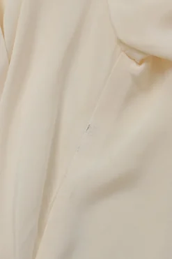 Ivory draped silk stand collar wrap-effect plunge neck blouse with high-low hem