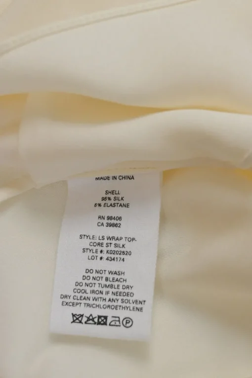 Ivory draped silk-blend wrap-effect plunge neck blouse with bishop sleeves