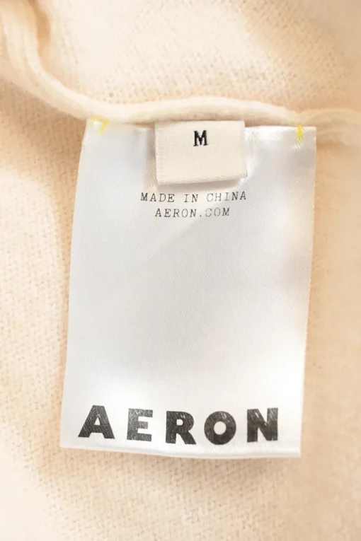 Ivory merino wool and cashmere-blend knit V-neck dolman sleeve gathered sweater with gold-finish motif