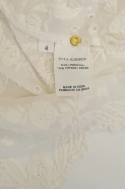 Ivory paisley-embroidered eyelet cotton half-sleeve scalloped hem blouse with ruffled collar