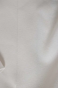 Ivory short ruffled sleeves top with front and side slits