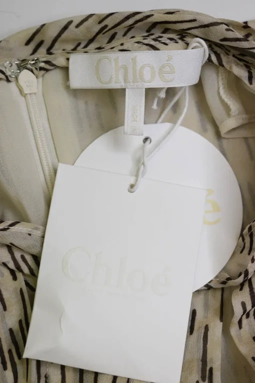 Ivory silk abstract stripe print pullover mock neck midi A-line dress with bias-cut handkerchief hem