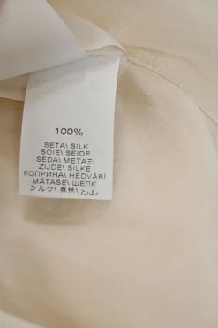 Ivory silk spread collar button-front blouse with chest patch pocket appliqué