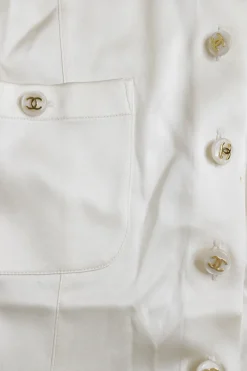 Ivory silk-blend satin scoop neck button-front short sleeve blouse with Coco Mark shank buttons