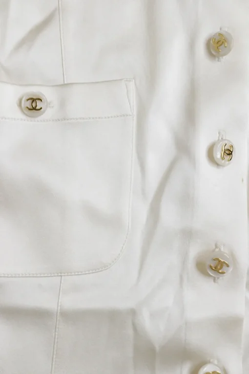 Ivory silk-blend satin scoop neck button-front short sleeve blouse with Coco Mark shank buttons