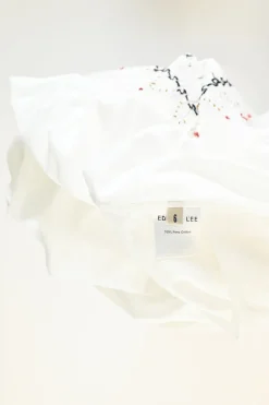 Ivory smocked pima cotton A-line knee-length bustier dress featuring calligraphic broderie motif