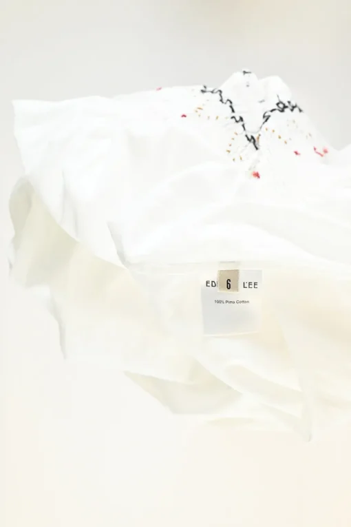 Ivory smocked pima cotton A-line knee-length bustier dress featuring calligraphic broderie motif