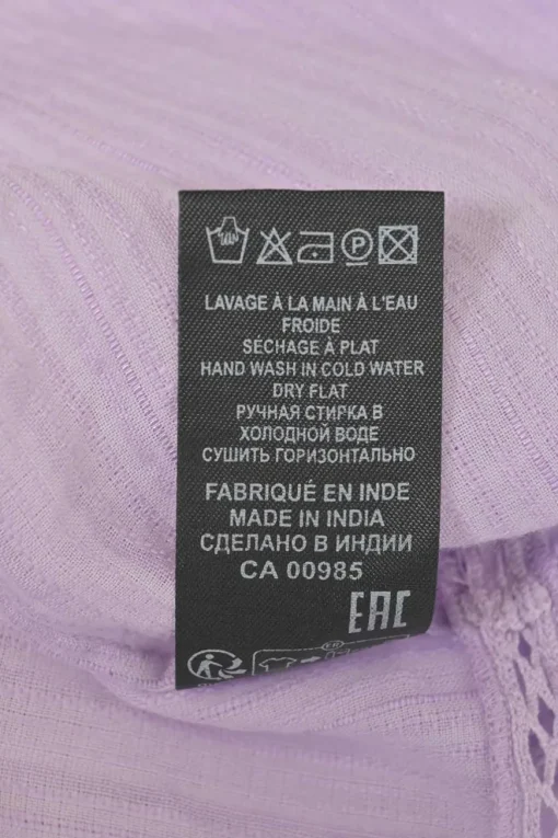 Lilac paneled halter-neck Lisio blouse with cutout edge trim inserts and ruffled hem