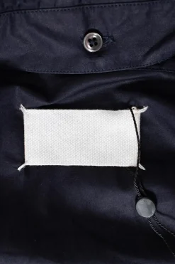 Navy long-sleeved top with strap connecting from waist to collar