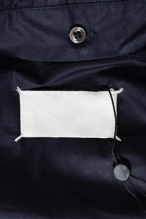 Navy long-sleeved top with strap connecting from waist to collar