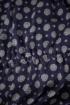 Navy off-shoulder knee-length dress with light blue motif pattern and belt-tie