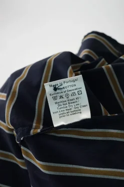 Navy paneled striped cotton poplin wrap-front asymmetric swing-style shift with flounce hem