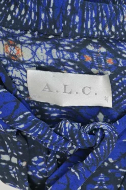 Navy silk kaleidoscopic abstract print pussy-bow blouse with flounce cuffs