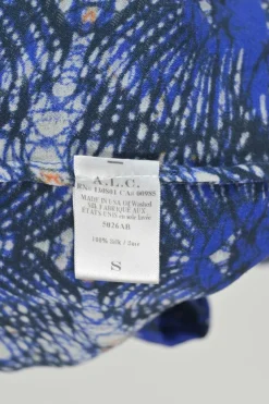Navy silk kaleidoscopic abstract print pussy-bow blouse with flounce cuffs