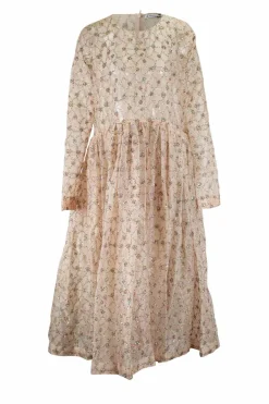 Off-white long-sleeved sheer maxi dress with sequined pattern and a nude slip dress