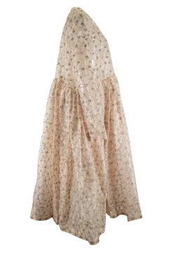 Off-white long-sleeved sheer maxi dress with sequined pattern and a nude slip dress
