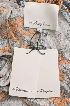 Orange and black floral hammered silk Lichen Bloom cowl midi dress with slash scye sleeves and handkerchief hem