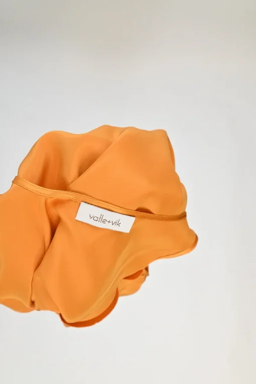 Orange bias-cut silk Ghost Palm plunge neck slip dress with spiral seam paneled hem