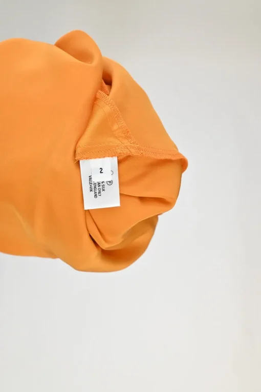 Orange bias-cut silk Ghost Palm plunge neck slip dress with spiral seam paneled hem