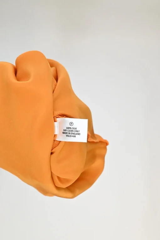 Orange bias-cut silk Ghost Palm plunge neck slip dress with spiral seam paneled hem