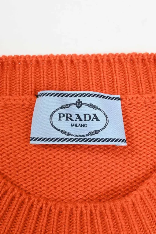 Orange crewneck pullover sweater featuring logo broderie motif