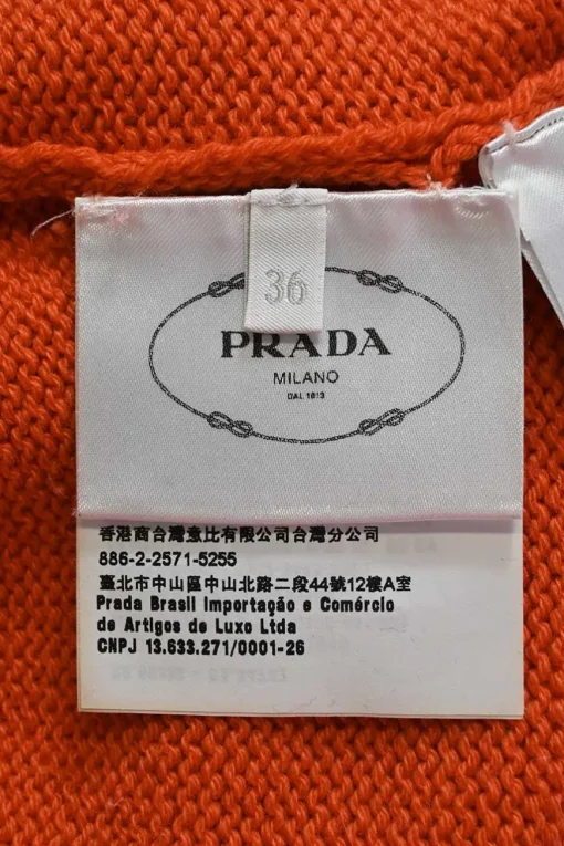 Orange crewneck pullover sweater featuring logo broderie motif
