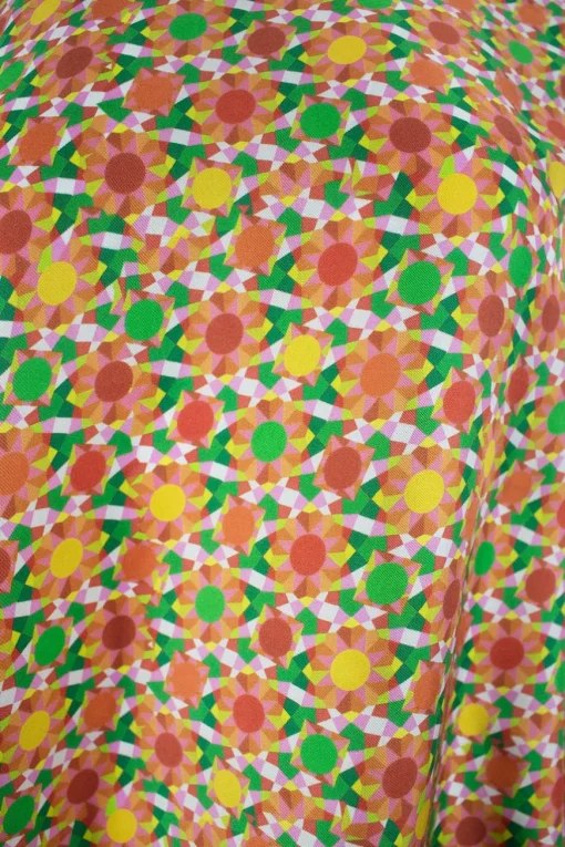 Orange long sleeve, silk and cotton top with polo collar and green geometrical pattern