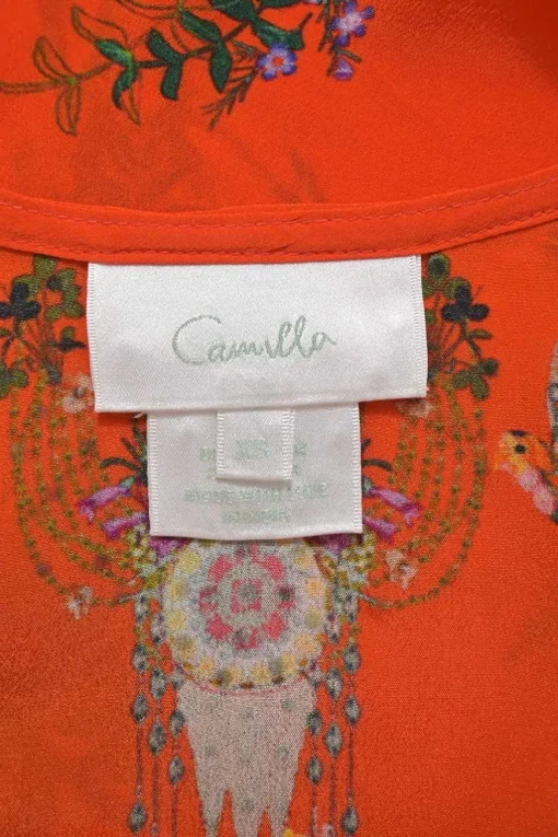 Orange tassel-tie front swing-style camisole featuring novelty floral bird motif
