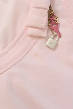Pink bow-embellished jersey knit tank top featuring house code charm appliqué
