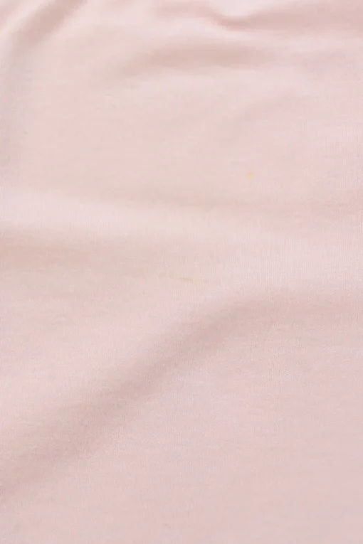 Pink bow-embellished jersey knit tank top featuring house code charm appliqué