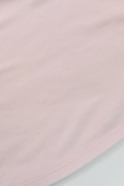 Pink bow-embellished jersey knit tank top featuring house code charm appliqué