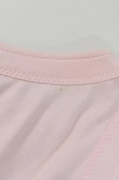 Pink bow-embellished jersey knit tank top featuring house code charm appliqué