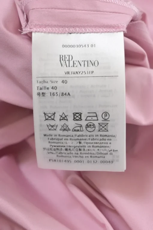 Pink draped polyester flutter sleeve pullover swing-style shift dress with ruffle hem and bow appliqué
