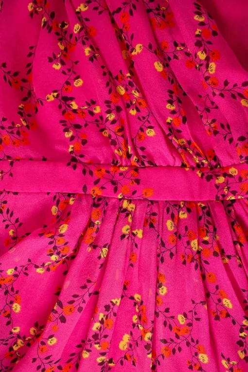 Pink sleeveless wrap mini dress with yellow red floral patterns