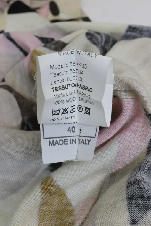 Pink wool funnel collar long sleeve knit top featuring abstract graphic intarsia motif