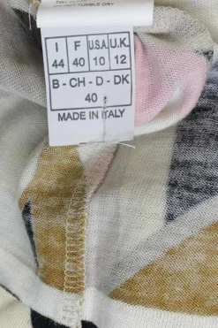 Pink wool funnel collar long sleeve knit top featuring abstract graphic intarsia motif