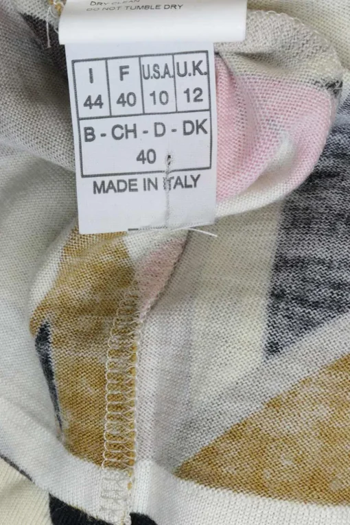 Pink wool funnel collar long sleeve knit top featuring abstract graphic intarsia motif