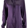 Purple long-sleeved top gathered on one side