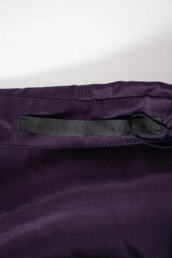 Purple long-sleeved top gathered on one side