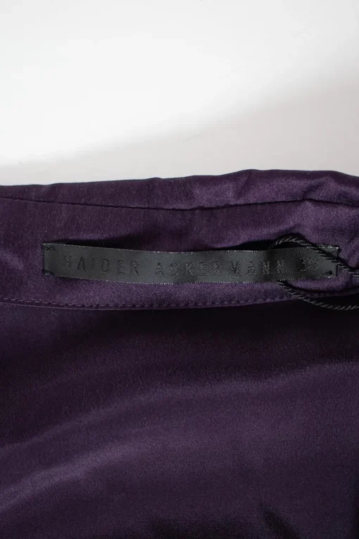 Purple long-sleeved top gathered on one side