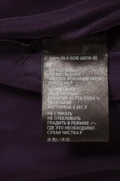 Purple long-sleeved top gathered on one side