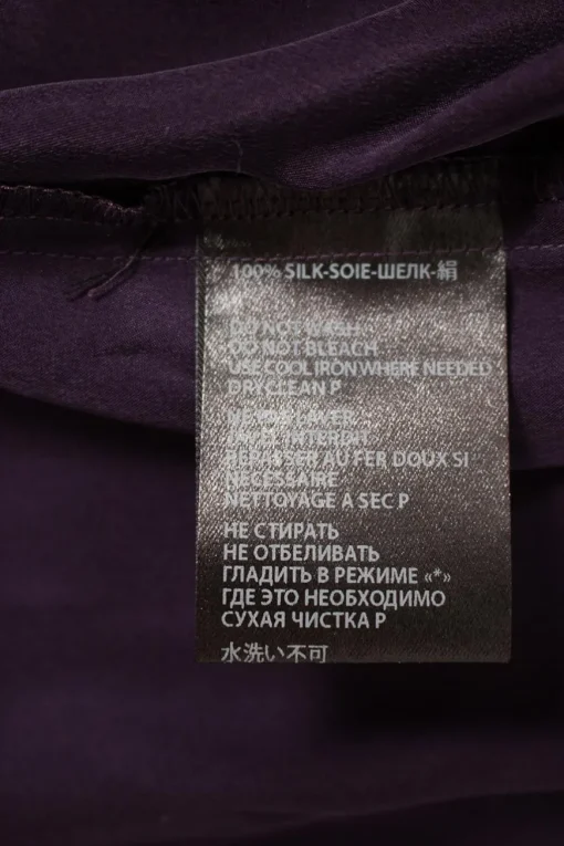 Purple long-sleeved top gathered on one side