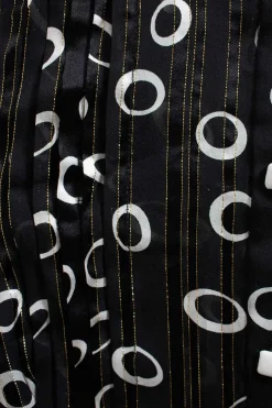 Raquel mid-length button up silk dress in black with white circles and gold detailing